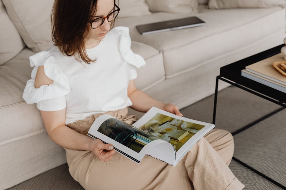 A relaxed person sitting on a floor with a laptop, looking comfortable at home.